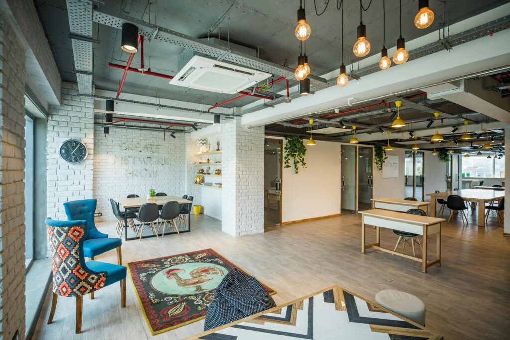Spacious contemporary office interior featuring stylish furniture, unique decor, and ample lighting.