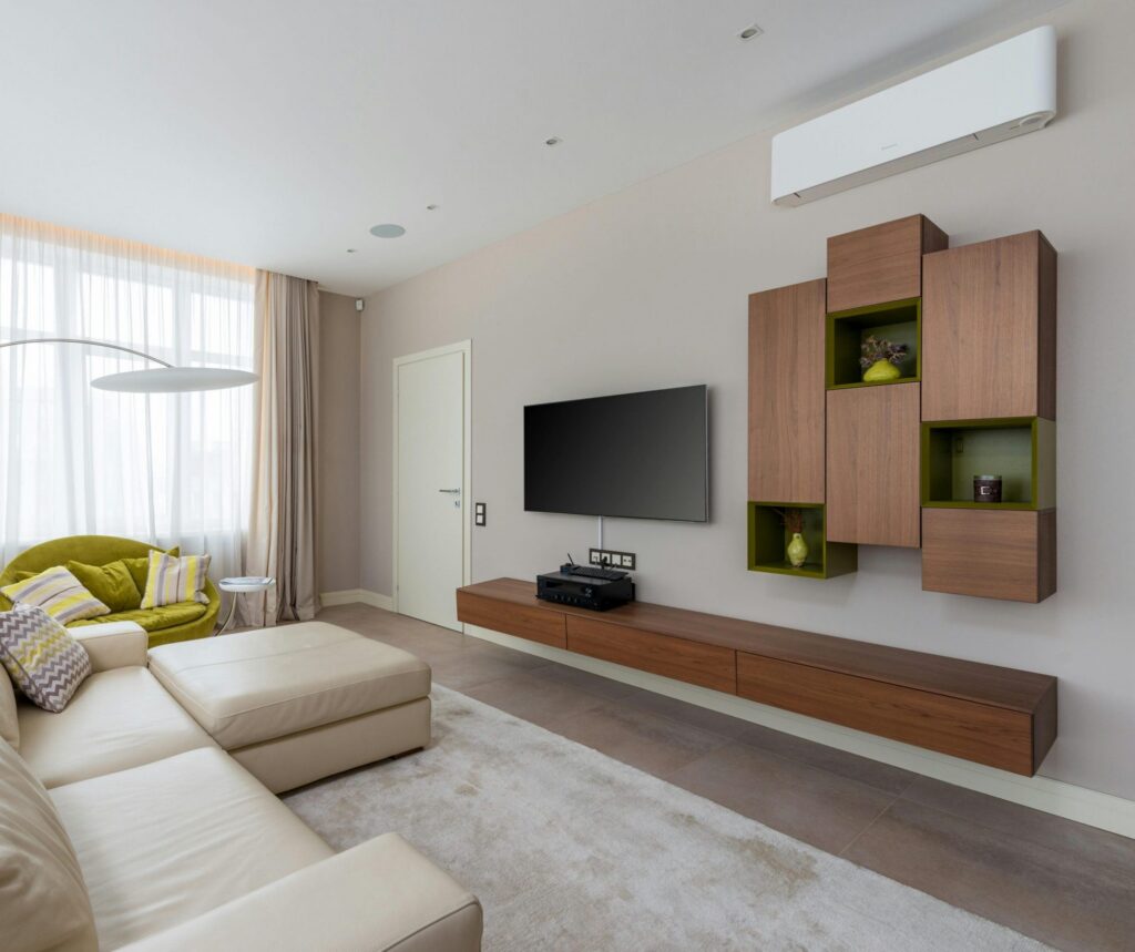 Interior of living room with stylish furniture and large comfortable sofa in luxury apartment in daylight